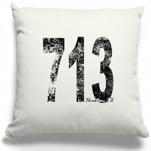 May include: White throw pillow with a black distressed graphic of the number 713 and the text "Houston, TX".