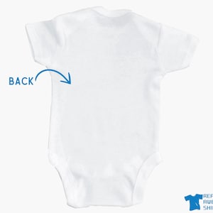 a white bodysuit with a blue arrow on it