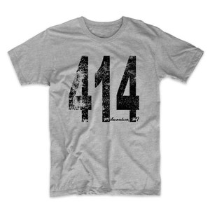 May include: A grey t-shirt with a black distressed graphic of the number 414 and the text "milwaukee, wi".