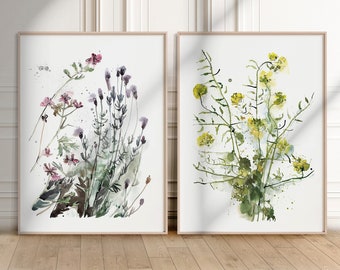 May include: Two framed watercolor paintings of wildflowers. The painting on the left features purple and pink flowers with green leaves. The painting on the right features yellow flowers with green leaves.
