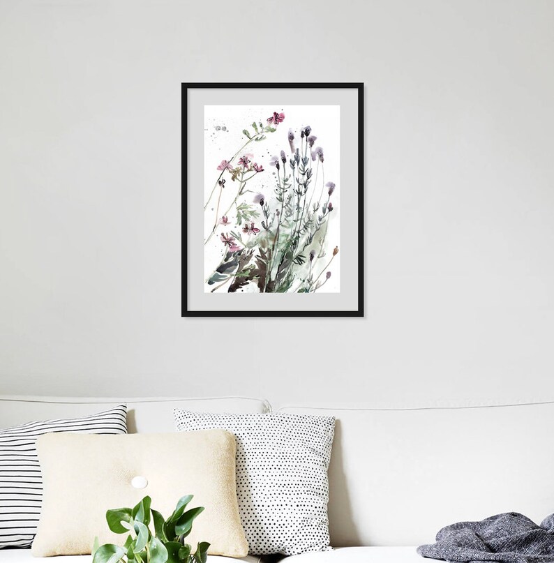 Puede incluir: Una pintura de acuarela enmarcada de un ramo de flores silvestres en tonos de rosa, morado y verde. Las flores est&aacute;n dispuestas en un estilo suelto y natural, y el fondo es un blanco suave.