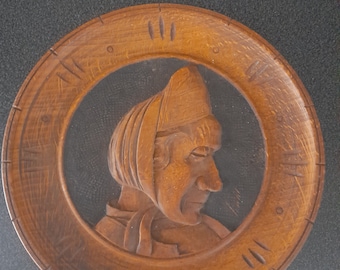 Vintage French wooden plate of traditional old woman