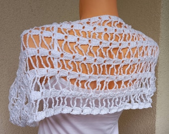 May include: White crochet shawl with a delicate openwork pattern. The shawl is draped over a mannequin and has a scalloped edge.