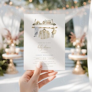 May include: A baby shower invitation with a watercolor illustration of a clothesline with baby clothes hanging on it. The invitation is for James Williams on April 22nd at 10:00 AM. The address is 1234 Tree Road, Sonoma, CA. RSVP by November 22nd.  Please call 323-456-7300.  Gifts can be purchased at Amazon and Target.