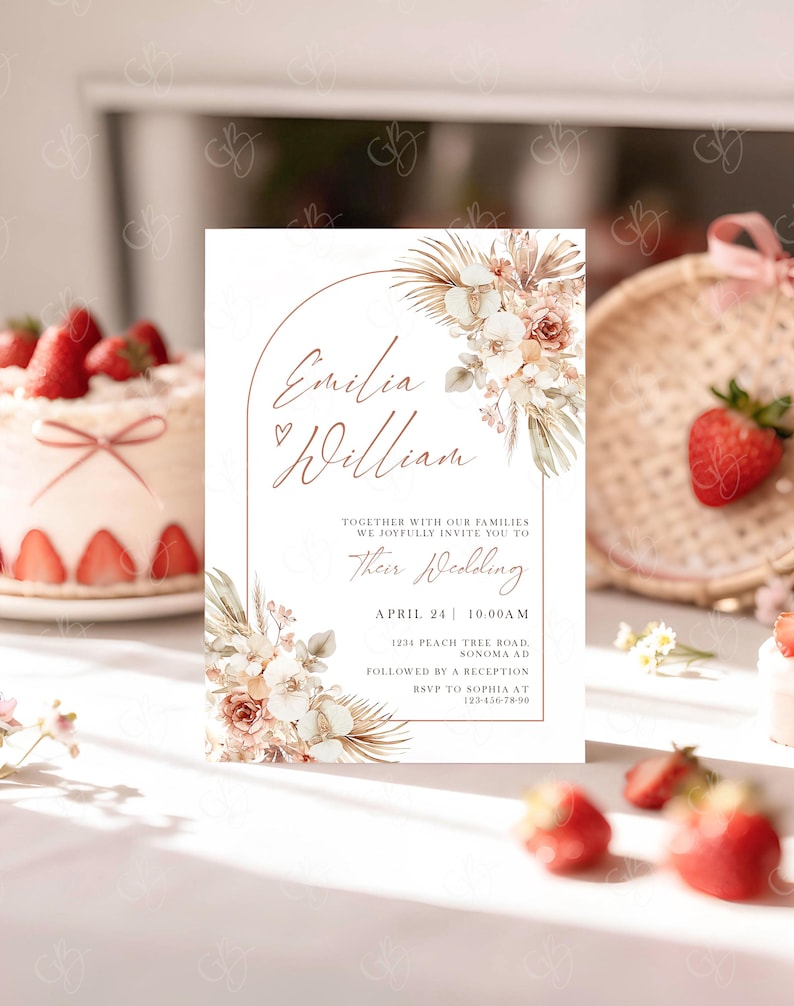 May include: Wedding invitation with the names "Emilia William" in elegant script, framed by floral arrangements in soft peach and cream tones. The invitation includes the wedding date, time, and location details.
