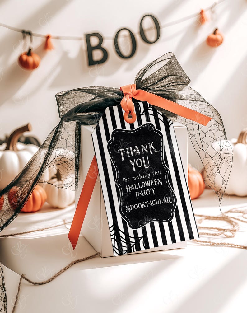 May include: Black and white striped gift tag with a black chalkboard style thank you message that says "Thank You for making this Halloween Party Spooktacular". The tag is tied with a black and orange ribbon and a black mesh bow.