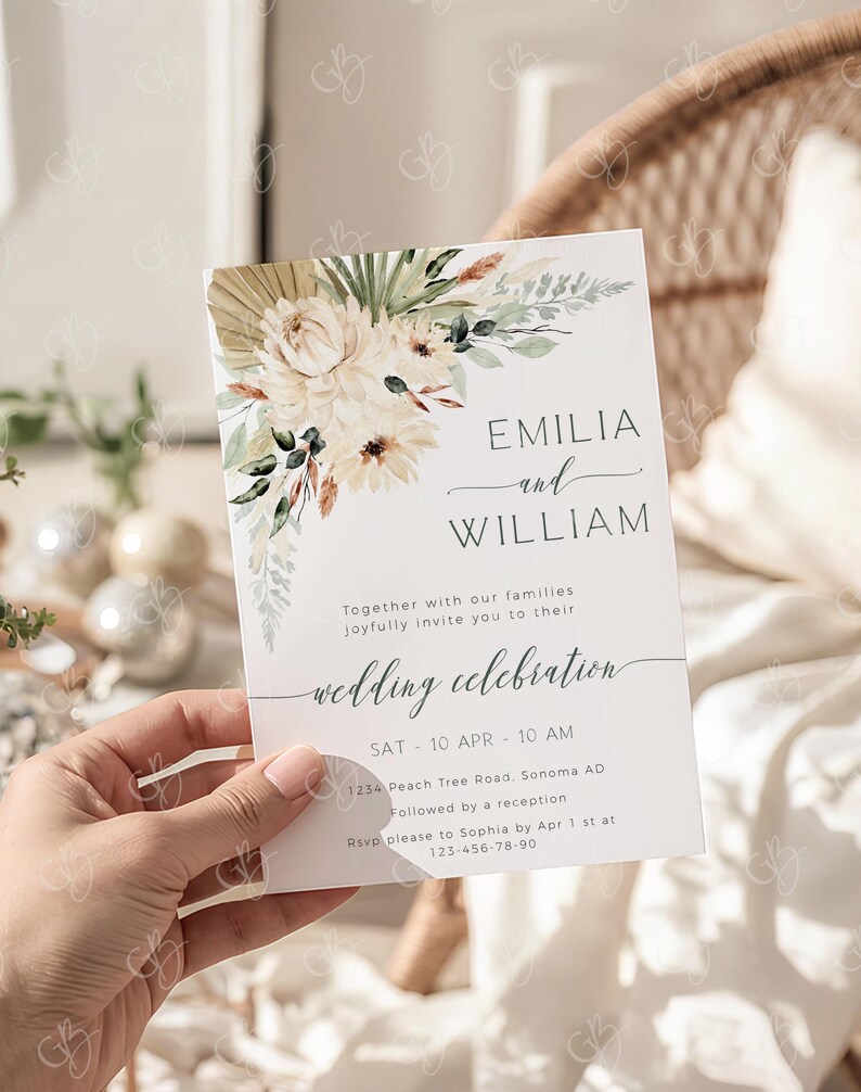 May include: A white wedding invitation with floral watercolor design. The invitation features the names "EMILIA and WILLIAM" and the words "wedding celebration". The date and time are also included.