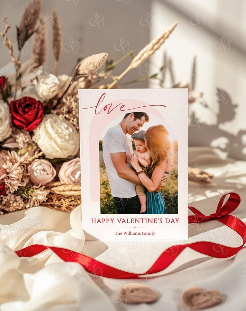 May include: Valentine's Day card with a family photo inside a pink arch. The word "love" is written in red script above the photo. Below the photo, the text reads "Happy Valentine's Day" and "The Williams Family."