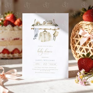 May include: A baby shower invitation with watercolor illustrations of baby clothes and accessories hanging on a wooden rack. The invitation text reads "Please join us for a baby shower" honoring James Williams, with date, time, and RSVP information.
