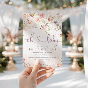 May include: A baby shower invitation with a floral design and the text "oh baby" in pink and purple. The invitation includes the name "Emilia Williams", the date "April 22th", and the time "10:00 am".