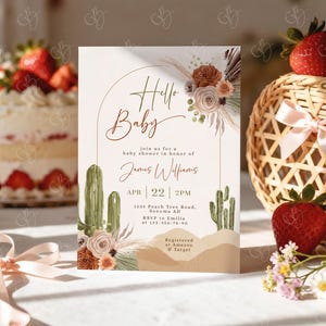 May include: A baby shower invitation with a desert theme. The invitation features the text "Hello Baby" in elegant script, along with details for the event. The design includes watercolor cacti, floral accents, and a desert landscape.