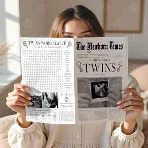 May include: A person holding a newspaper titled "The Newborn Times" announcing "Coming Soon TWINS." The newspaper includes a word search puzzle and a sonogram image. The paper is cream-colored with black text and illustrations.