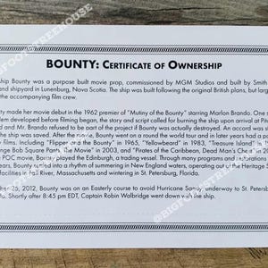 May include: A white certificate of ownership for the ship Bounty, a movie prop. The certificate details the ship's history, including its use in films like "Mutiny of the Bounty" and "Pirates of the Caribbean".