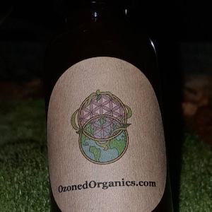 May include: A small brown glass bottle with a label that says "OzonedOrganics.com". The label features a graphic of a flower and a globe.