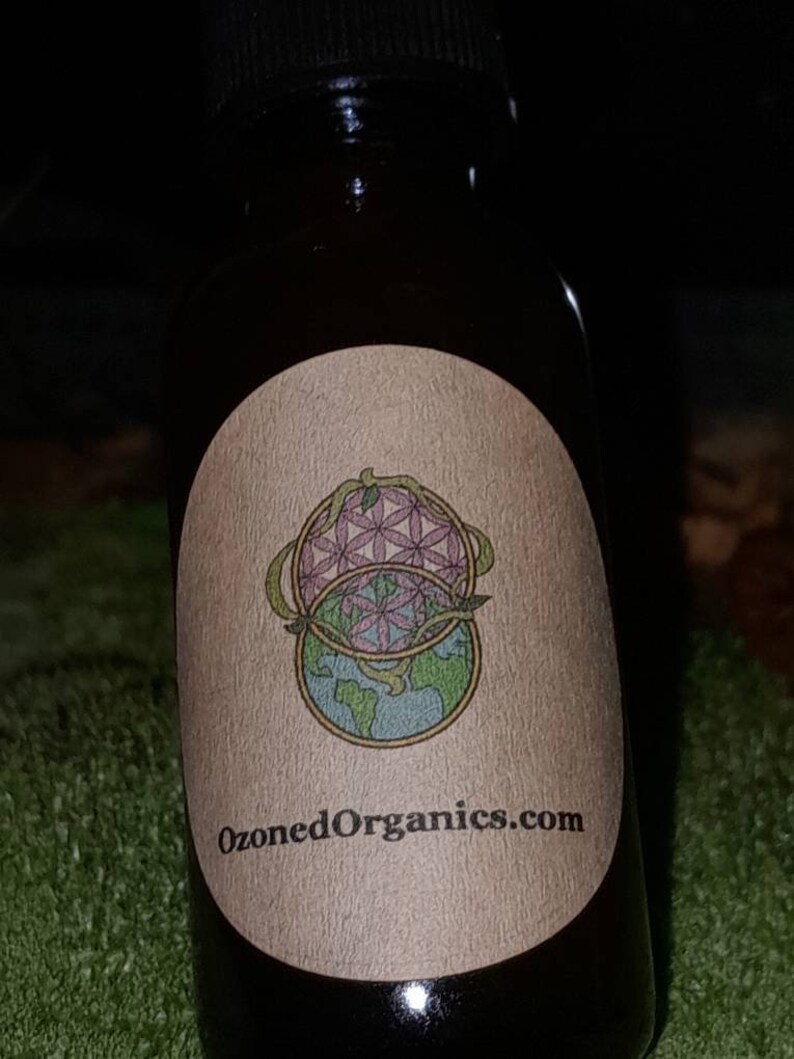 May include: A small brown glass bottle with a label that says "OzonedOrganics.com". The label features a graphic of a flower and a globe.