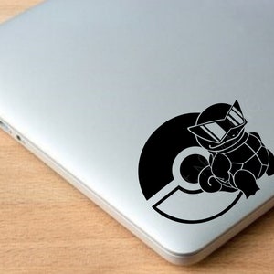 May include: Black and white sticker of a cartoon turtle wearing sunglasses and sitting on a Pokeball.