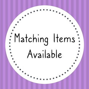 May include: A white circle with a black dotted border on a purple striped background. The text "Matching Items Available" is written in black inside the circle.
