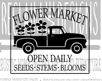 May include: Black and white silhouette of a pickup truck with flowers in the bed. The truck has the words "FLOWER MARKET" above it and "OPEN DAILY SEEDS STEMS BLOOMS" below it.