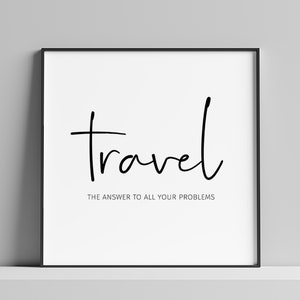 May include: A framed print with the word "travel" in a handwritten font. Below, the text reads "THE ANSWER TO ALL YOUR PROBLEMS". The print is in a black frame, set against a white background.