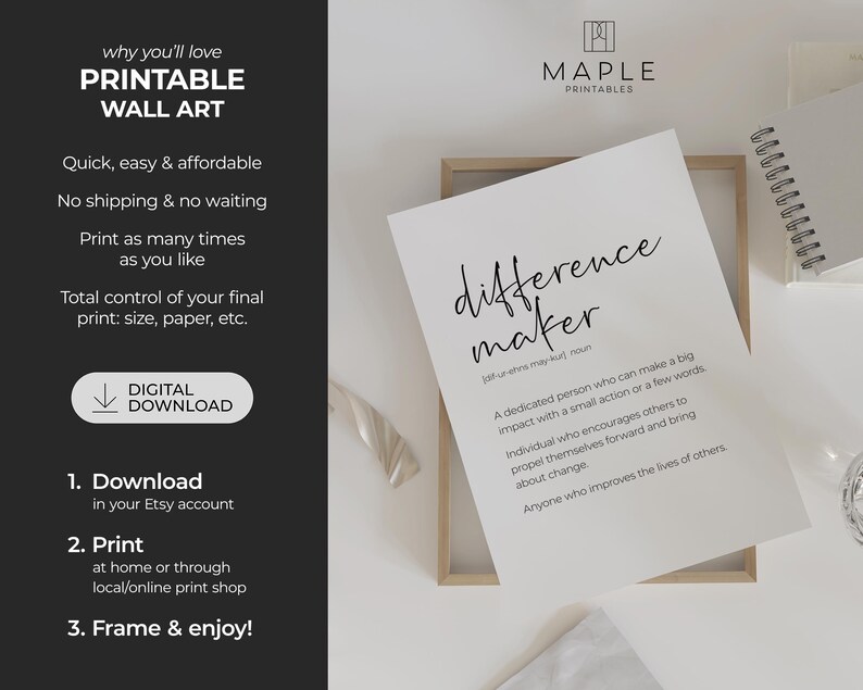 May include: A white printable wall art print with the words "difference maker" in a handwritten font. The definition of the phrase is also included. The print is displayed in a wooden frame, with a notebook and other items in the background.
