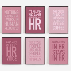 May include: Six framed prints with pink backgrounds and black frames. Each print features white text with HR-related quotes, including "Nothing Surprises Me I Work in Human Resources" and "What Happens in HR Stays in HR."