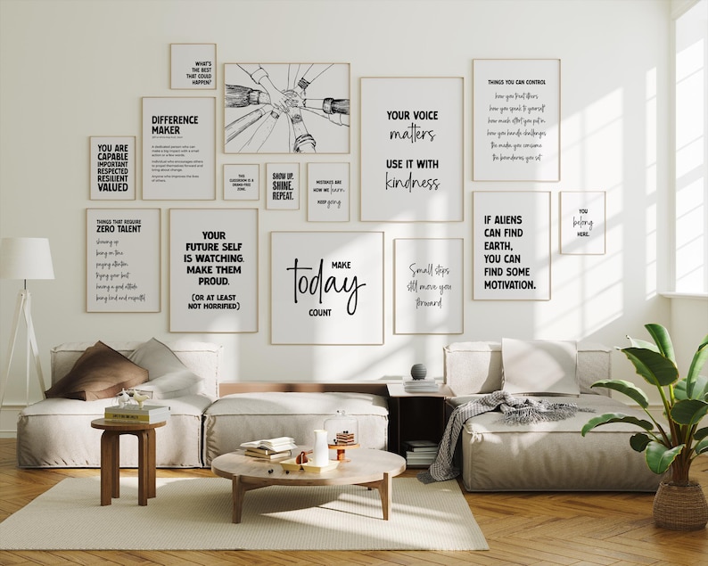May include: A collection of framed motivational posters with black text on a white background, displayed on a white wall. The posters feature various quotes and phrases, including "Make Today Count" and "Your Voice Matters." The room is furnished with neutral-toned sofas and wooden furniture.