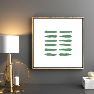 May include: A framed abstract print with a white background and a series of horizontal green brushstrokes.