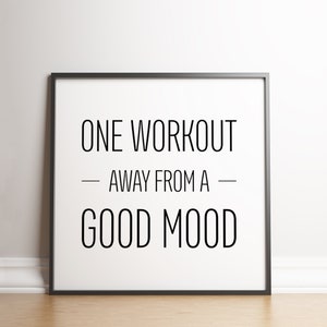 May include: Black and white motivational quote in a black frame on a white wall. The quote reads "One workout away from a good mood."