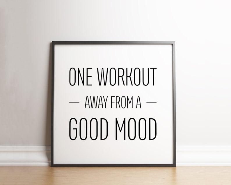 May include: Black and white motivational quote in a black frame on a white wall. The quote reads "One workout away from a good mood."