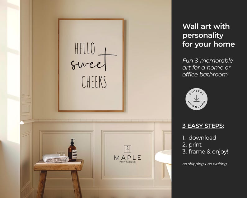 May include: A framed wall art print with the text "Hello Sweet Cheeks" in a bathroom setting. The print is in a light-colored frame. A small wooden stool holds a towel, soap dispenser, and a small glass. The wall art is for a home or office bathroom.
