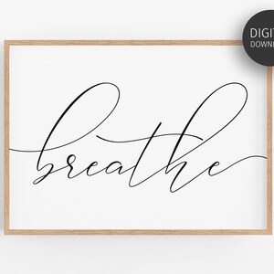 May include: A printable wall art design featuring the word "breathe" in a modern calligraphy style. The word is written in black ink on a white background.