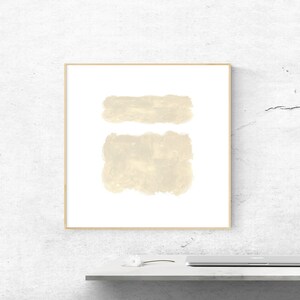 May include: A framed abstract art print with two beige brushstrokes on a white background.