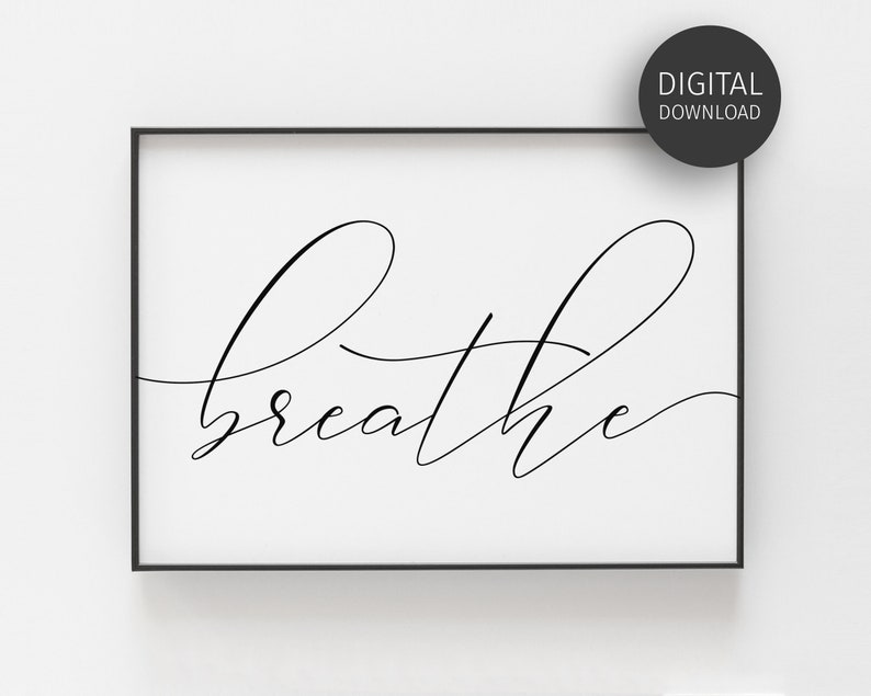 May include: A black and white printable wall art print with the word "breathe" written in a cursive font.
