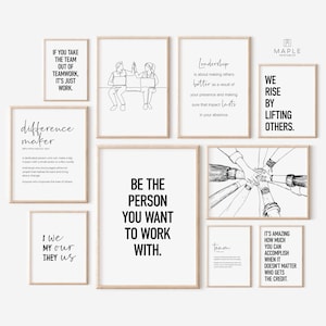 May include: A collection of framed art prints with motivational quotes and line drawings. The prints feature phrases like "Be the person you want to work with" and "We rise by lifting others." The frames are a light wood color.