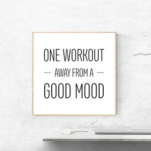 May include: A framed motivational quote on a white background with a wooden frame. The quote reads "One workout away from a good mood."