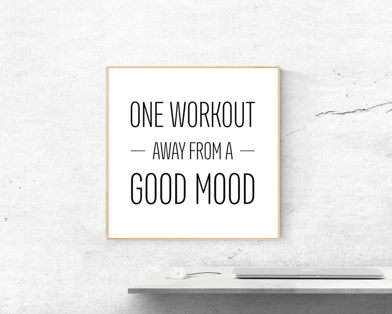 May include: A framed motivational quote on a white background with a wooden frame. The quote reads "One workout away from a good mood."