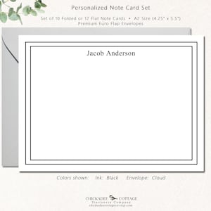 May include: Personalized note card set with a black border and the name "Jacob Anderson" printed in black ink. The set includes 10 folded or 12 flat note cards in A2 size (4.25" x 5.5") and premium Euro flap envelopes. The colors shown are black ink and cloud envelope.