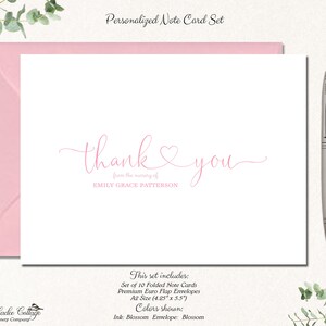 May include: A personalized note card set with a pink envelope and a silver pen. The card features the words "thank you" in a delicate script, with the name "EMILY GRACE PATTERSON" below. The set includes 10 folded note cards.