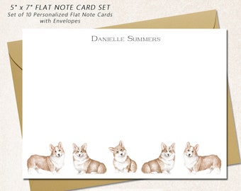 May include: Set of 10 personalised 5 x 7 inch flat note cards with envelopes. The cards feature a watercolour illustration of six corgis in a row. The text "DANIELLE SUMMERS" is printed at the top of the card. The text "INK: BLACK ENVELOPE: HARVEST" is printed at the bottom of the card. The text "CHICKADEE COTTAGE Stationery Company" is printed at the bottom right corner of the card.