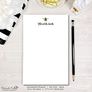 May include: Personalized notepad with a bee illustration and the name "Meredith Smith" printed in black ink. The notepad is 5.5 inches by 8.5 inches and has 50 or 100 sheets.