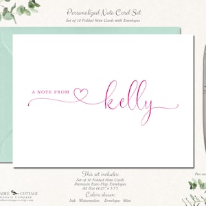May include: A personalized note card set with a white card and mint envelope. The card features the text "A NOTE FROM" and the name "kelly" in a watermelon pink script font. A silver pen rests beside the card.