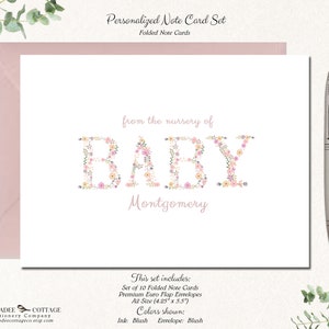 May include: A set of 10 folded note cards with blush colored envelopes. The cards feature a floral design spelling out the word "BABY" with the name "Montgomery" below. The text "from the nursery of" is above the floral design. The cards are A2 size (4.25" x 5.5").