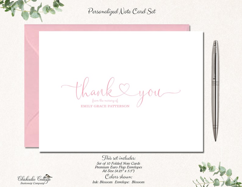 May include: A personalized note card set with a pink envelope and a silver pen. The card features the words "thank you" in a delicate script, with the name "EMILY GRACE PATTERSON" below. The set includes 10 folded note cards.