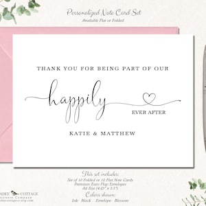 May include: A personalized note card set with a pink envelope. The card reads "Thank you for being part of our happily ever after" with the names Katie & Matthew. A silver pen rests on the right. The set includes A2 size cards.