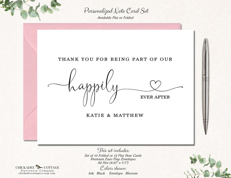 May include: A personalized note card set with a pink envelope. The card reads "Thank you for being part of our happily ever after" with the names Katie & Matthew. A silver pen rests on the right. The set includes A2 size cards.