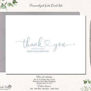 May include: A set of 10 folded note cards with envelopes. The cards are white with blue calligraphy that says "thank you" and "from the marriage of JAXON LOUIS STRATTON". The envelopes are light grey.