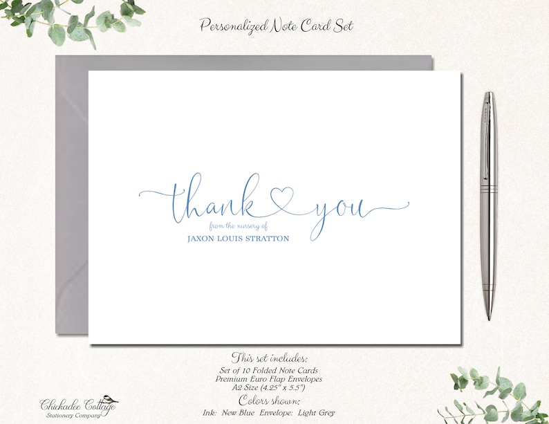 May include: A set of 10 folded note cards with envelopes. The cards are white with blue calligraphy that says "thank you" and "from the marriage of JAXON LOUIS STRATTON". The envelopes are light grey.
