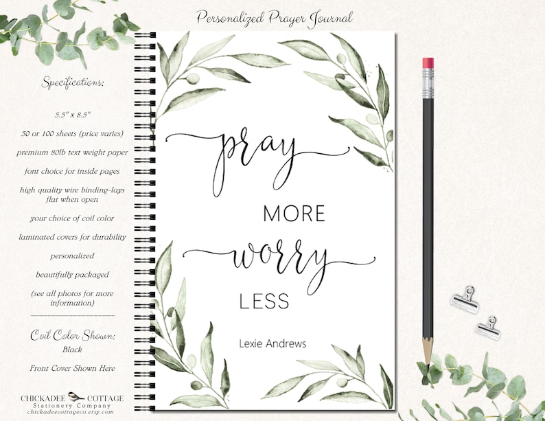 May include: A white prayer journal with a green watercolor floral design and the text "pray more worry less". The journal is 5.5 inches by 8.5 inches and has a black coil binding. The front cover also includes the name "Lexie Andrews".
