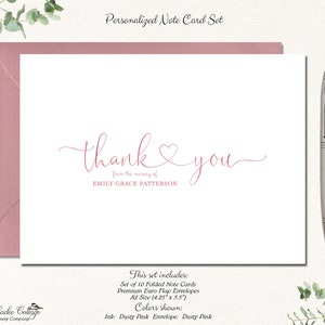 May include: A personalized note card set with a white card featuring the words "thank you" in pink script, with a heart symbol. The set includes pink envelopes and a silver pen. The text reads "from the nursery of EMILY GRACE PATTERSON".
