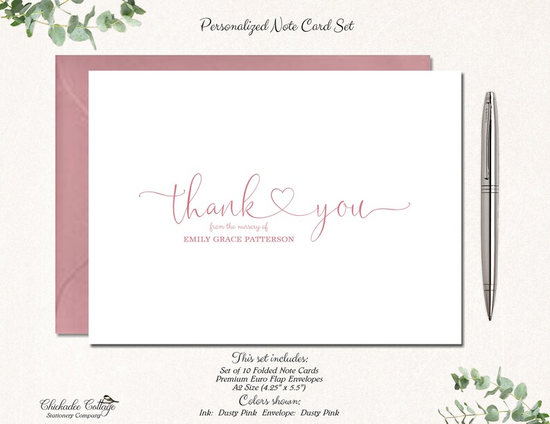May include: A personalized note card set with a white card featuring the words "thank you" in pink script, with a heart symbol. The set includes pink envelopes and a silver pen. The text reads "from the nursery of EMILY GRACE PATTERSON".